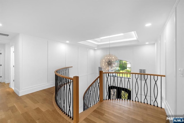 452 Oregon St, Paramus, NJ 07652 - hall featuring an upstairs landing, wood finished floors, a chandelier, a tray ceiling, and recessed lighting