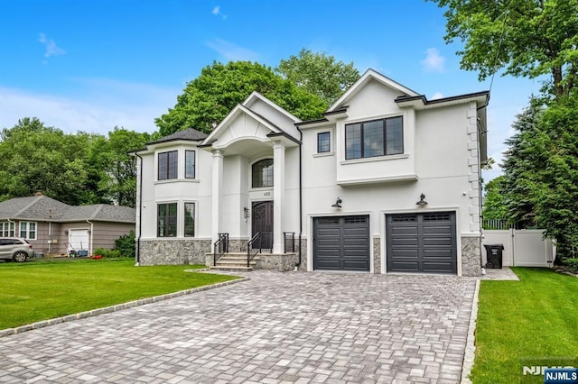 452 Oregon St, Paramus, NJ 07652 - view of front of house featuring stone siding, decorative driveway, an attached garage, and stucco siding