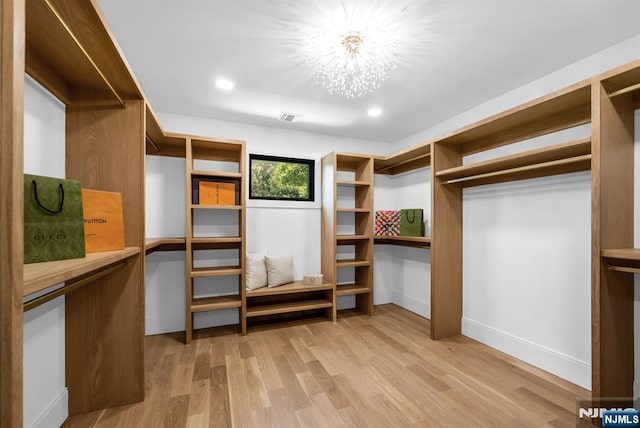 452 Oregon St, Paramus, NJ 07652 - walk in closet featuring light wood finished floors and a chandelier