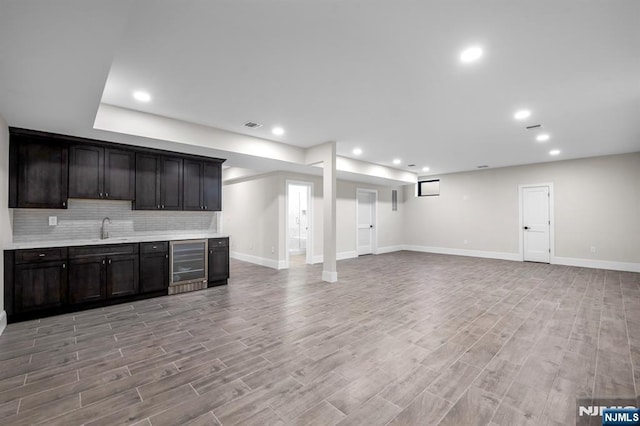 452 Oregon St, Paramus, NJ 07652 - kitchen featuring beverage cooler, tasteful backsplash, recessed lighting, light countertops, and light wood-style floors