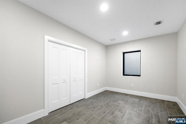 452 Oregon St, Paramus, NJ 07652 - unfurnished bedroom with wood finished floors, recessed lighting, and a closet