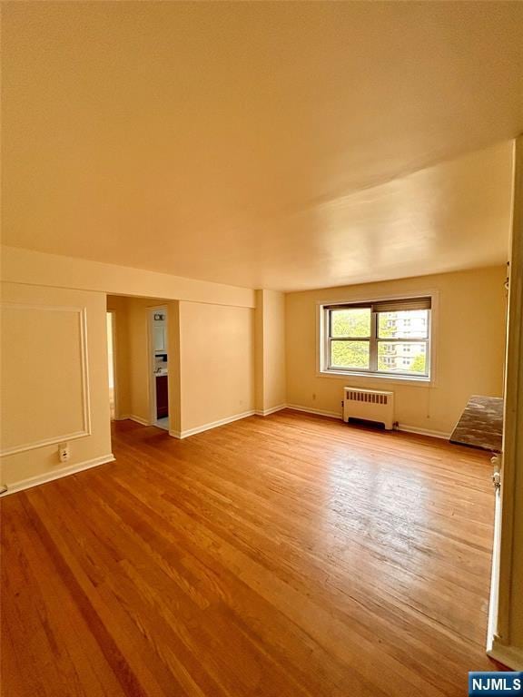 2195 N Central Rd Unit 4H, Fort Lee, NJ 07024 - spare room featuring radiator heating unit and wood finished floors