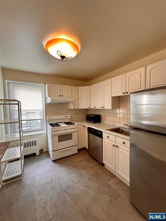 2195 N Central Rd Unit 4H, Fort Lee, NJ 07024 - kitchen featuring appliances with stainless steel finishes, under cabinet range hood, white cabinetry, and tasteful backsplash
