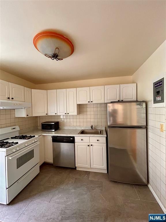 2195 N Central Rd Unit 4H, Fort Lee, NJ 07024 - kitchen with appliances with stainless steel finishes, under cabinet range hood, tile walls, white cabinets, and light countertops