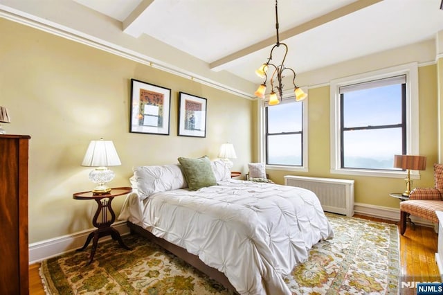 375 Mount Prospect Unit 6B, Newark, NJ 07104 - bedroom with radiator, beamed ceiling, and wood finished floors