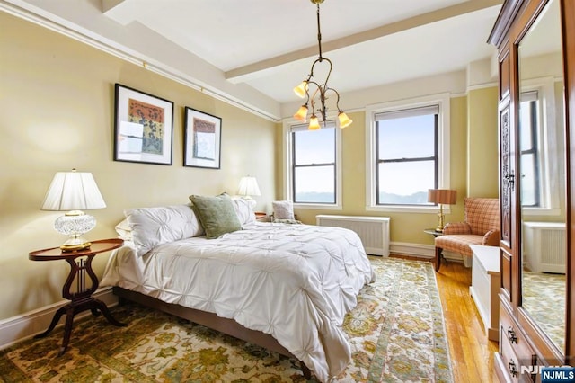375 Mount Prospect Unit 6B, Newark, NJ 07104 - bedroom featuring radiator, light wood-type flooring, beam ceiling, and a chandelier