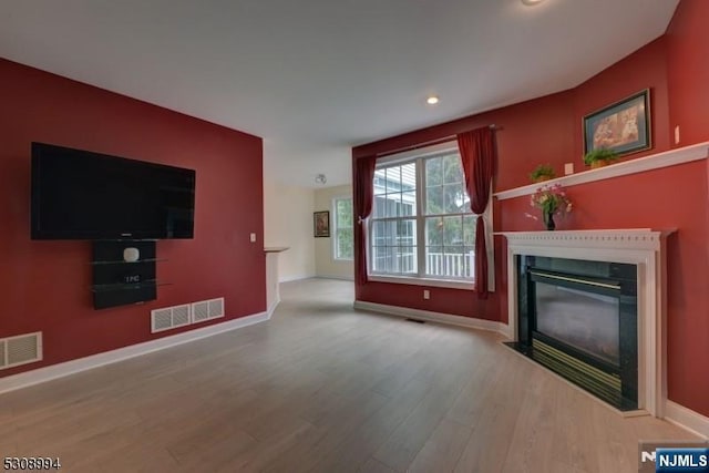 140 Levinberg Ln, Wayne, NJ 07470 - unfurnished living room with wood finished floors, a fireplace with flush hearth, and recessed lighting