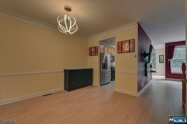 140 Levinberg Ln, Wayne, NJ 07470 - unfurnished dining area featuring a chandelier, light wood-style flooring, and ornamental molding