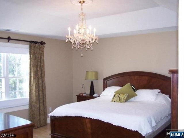 140 Levinberg Ln, Wayne, NJ 07470 - bedroom featuring a chandelier and light wood-style floors