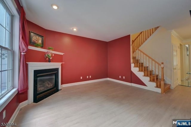 140 Levinberg Ln, Wayne, NJ 07470 - unfurnished living room with wood finished floors, healthy amount of natural light, a fireplace with flush hearth, stairs, and recessed lighting