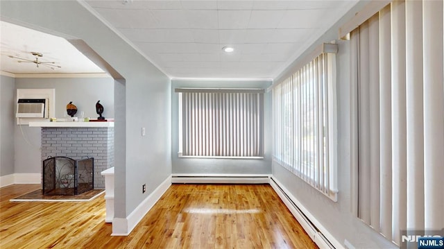 39 Boyden Pkwy, Maplewood, NJ 07040 - unfurnished living room with ornamental molding, baseboard heating, wood finished floors, and a fireplace