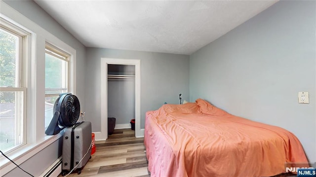 39 Boyden Pkwy, Maplewood, NJ 07040 - bedroom featuring light wood-type flooring, a closet, and baseboard heating
