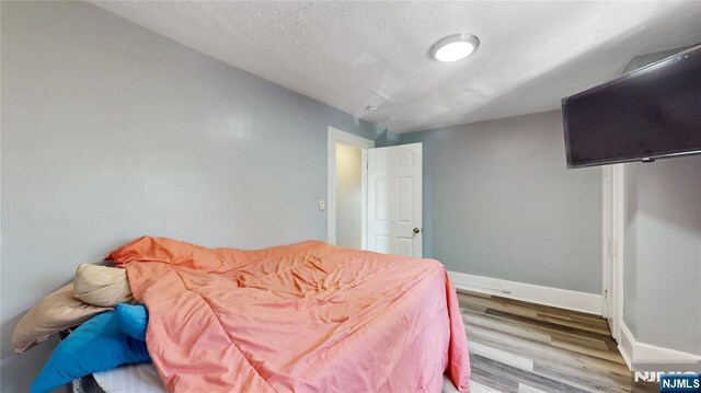 39 Boyden Pkwy, Maplewood, NJ 07040 - bedroom featuring wood finished floors and a textured ceiling