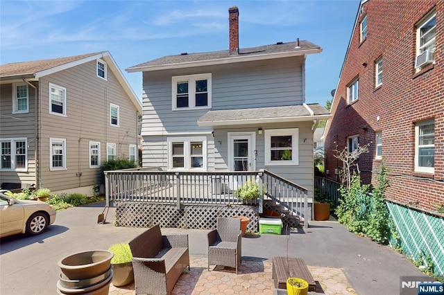 39 Boyden Pkwy, Maplewood, NJ 07040 - back of property featuring a patio, a chimney, cooling unit, and roof with shingles