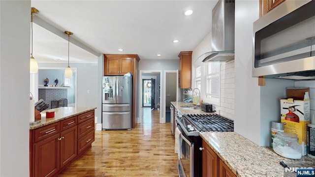 39 Boyden Pkwy, Maplewood, NJ 07040 - kitchen featuring stainless steel appliances, wall chimney range hood, decorative backsplash, light wood-style flooring, and recessed lighting