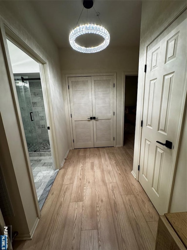 7206 Richmond Rd Unit 7206, West Milford, NJ 07480 - corridor with light wood-style flooring and a chandelier