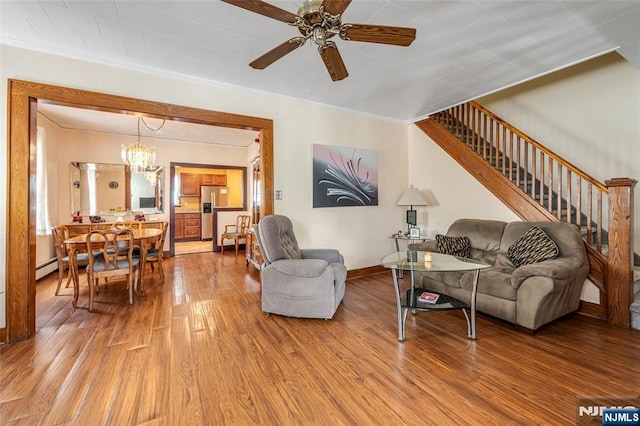 1 Whittlesey Ave, West Orange, NJ 07052 - living area featuring wood finished floors, a chandelier, a ceiling fan, crown molding, and stairway