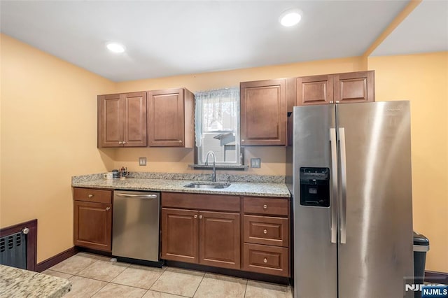1 Whittlesey Ave, West Orange, NJ 07052 - kitchen with appliances with stainless steel finishes, light stone countertops, light tile patterned flooring, recessed lighting, and radiator