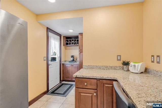 1 Whittlesey Ave, West Orange, NJ 07052 - kitchen featuring light tile patterned flooring, brown cabinets, light stone counters, and recessed lighting