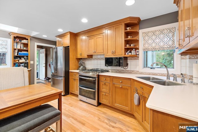 747 Mildred St, Teaneck, NJ 07666 - kitchen with stainless steel appliances, open shelves, decorative backsplash, light countertops, and light wood finished floors