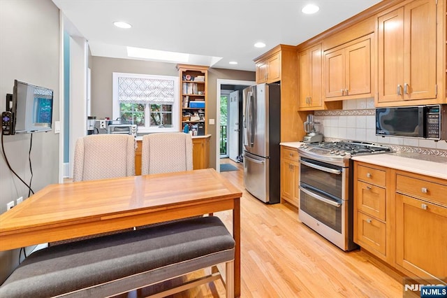 747 Mildred St, Teaneck, NJ 07666 - kitchen with appliances with stainless steel finishes, tasteful backsplash, light countertops, light wood-type flooring, and recessed lighting