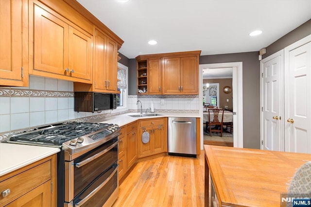 747 Mildred St, Teaneck, NJ 07666 - kitchen featuring stainless steel appliances, light wood-type flooring, wooden counters, open shelves, and tasteful backsplash