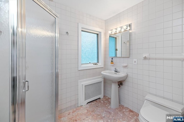 747 Mildred St, Teaneck, NJ 07666 - bathroom with tile walls, a shower stall, and radiator heating unit