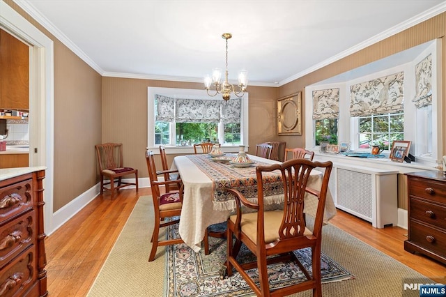 747 Mildred St, Teaneck, NJ 07666 - dining area with a chandelier, crown molding, and light wood finished floors