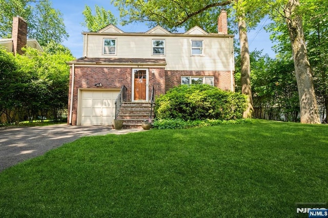 279 Jefferson Ave, Cresskill, NJ 07626 - traditional-style house featuring brick siding, driveway, a front yard, and a chimney