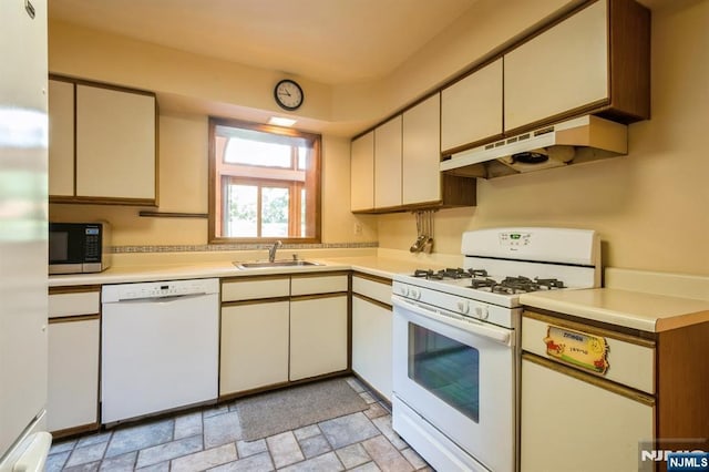 279 Jefferson Ave, Cresskill, NJ 07626 - kitchen featuring white appliances, under cabinet range hood, light countertops, stone finish flooring, and cream cabinetry