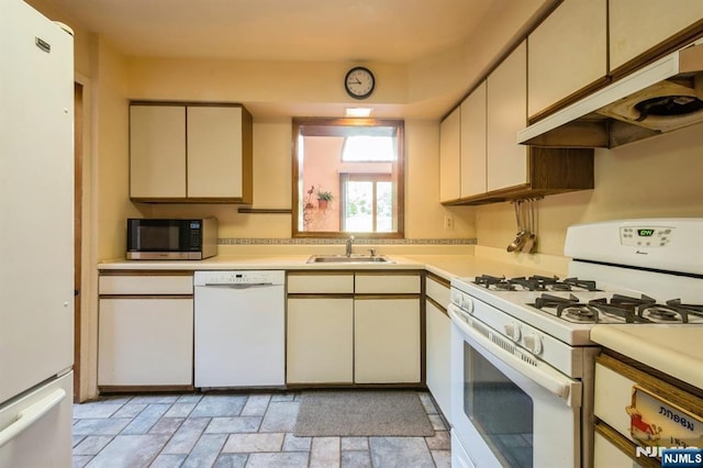 279 Jefferson Ave, Cresskill, NJ 07626 - kitchen with white appliances, under cabinet range hood, light countertops, light stone finish floors, and cream cabinets