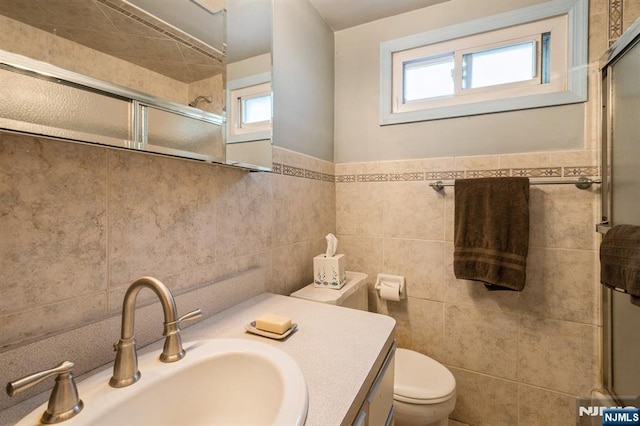 279 Jefferson Ave, Cresskill, NJ 07626 - full bathroom featuring tile walls, a shower with door, and vanity