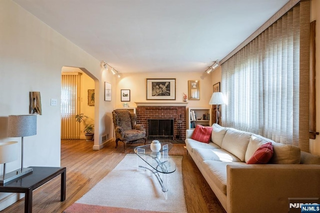 279 Jefferson Ave, Cresskill, NJ 07626 - living room featuring arched walkways, plenty of natural light, wood finished floors, and rail lighting