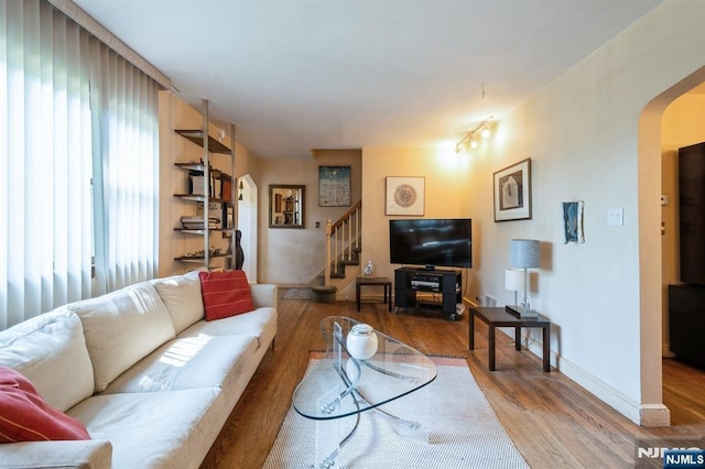279 Jefferson Ave, Cresskill, NJ 07626 - living area with arched walkways, stairway, and wood finished floors