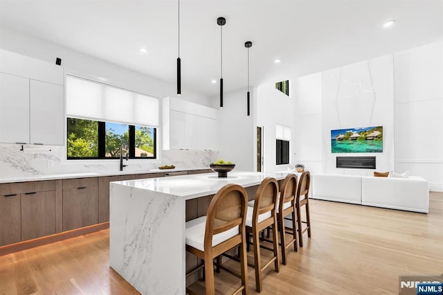 404 Willard Rd, Paramus, NJ 07652 - kitchen with modern cabinets, light wood-style floors, and recessed lighting