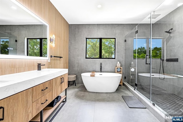 404 Willard Rd, Paramus, NJ 07652 - full bathroom with finished concrete floors, a shower stall, a freestanding bath, and double vanity