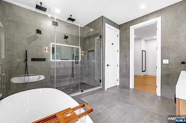 404 Willard Rd, Paramus, NJ 07652 - full bathroom with a soaking tub, a stall shower, vanity, and recessed lighting