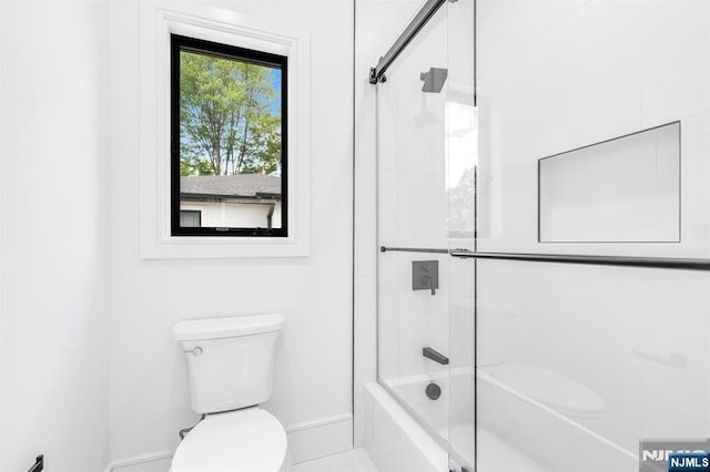 404 Willard Rd, Paramus, NJ 07652 - bathroom featuring toilet and shower / bath combination with glass door