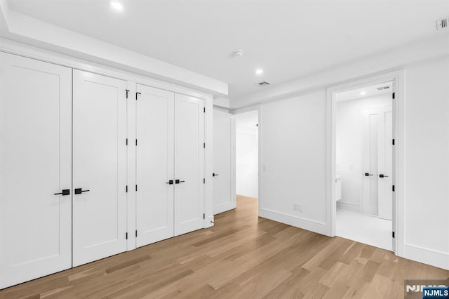 404 Willard Rd, Paramus, NJ 07652 - unfurnished bedroom featuring recessed lighting, light wood finished floors, two closets, and ensuite bathroom