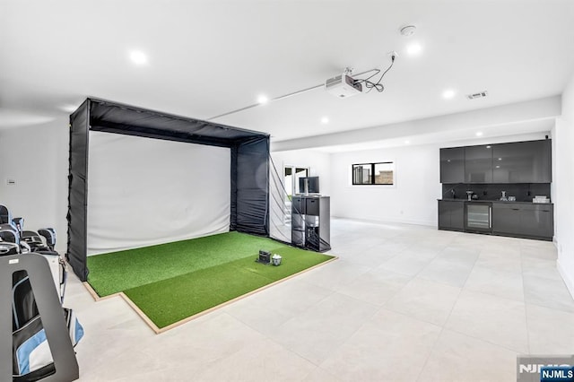 404 Willard Rd, Paramus, NJ 07652 - rec room with golf simulator, recessed lighting, light tile patterned floors, and beverage cooler