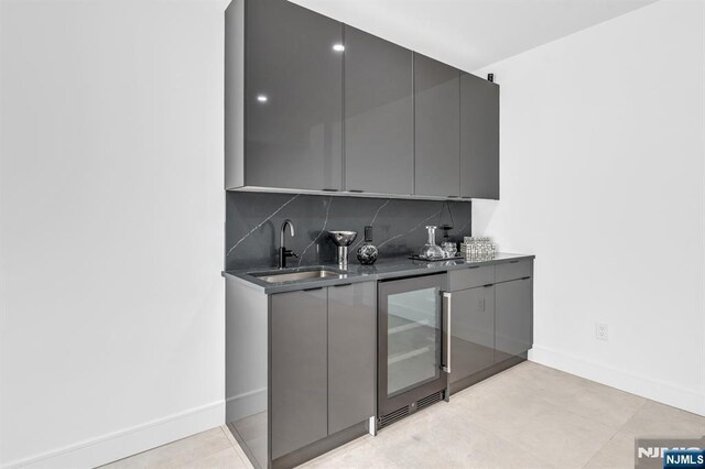 404 Willard Rd, Paramus, NJ 07652 - indoor wet bar featuring wine cooler, tasteful backsplash, and light tile patterned floors
