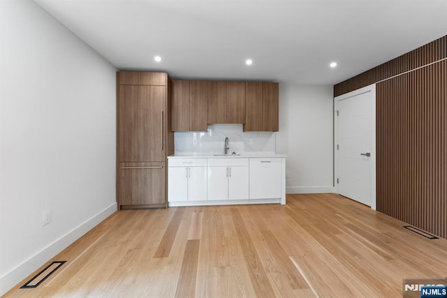 135 Old Palisade Rd Unit B, Fort Lee, NJ 07024 - kitchen featuring light countertops, light wood finished floors, recessed lighting, white cabinetry, and brown cabinetry