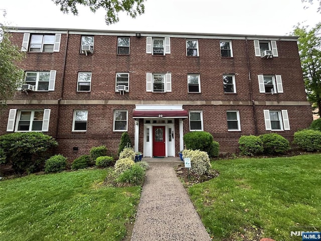 22 Cedar St Unit 2B, Ridgefield Park, NJ 07660 - view of front of property featuring a front yard, brick siding, and cooling unit