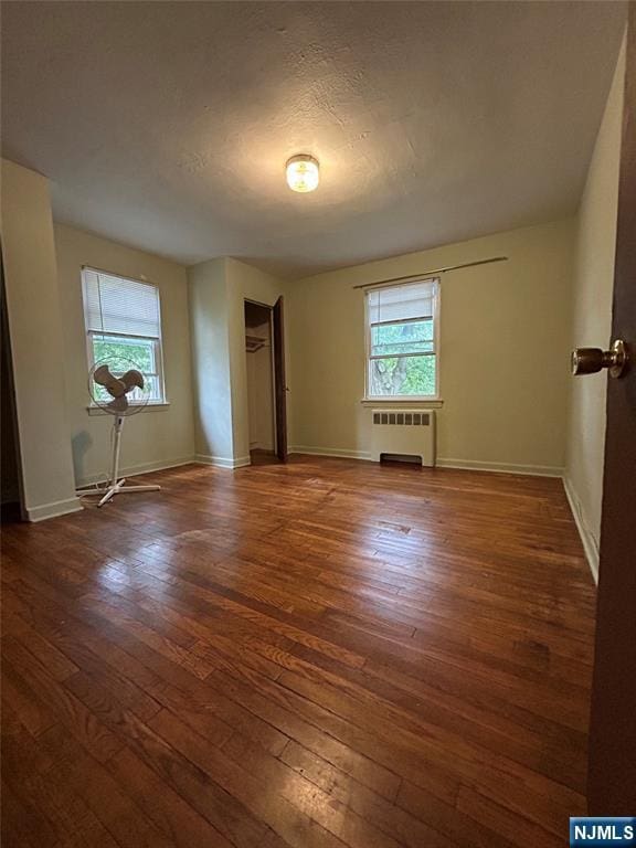 22 Cedar St Unit 2B, Ridgefield Park, NJ 07660 - spare room with radiator and hardwood / wood-style floors