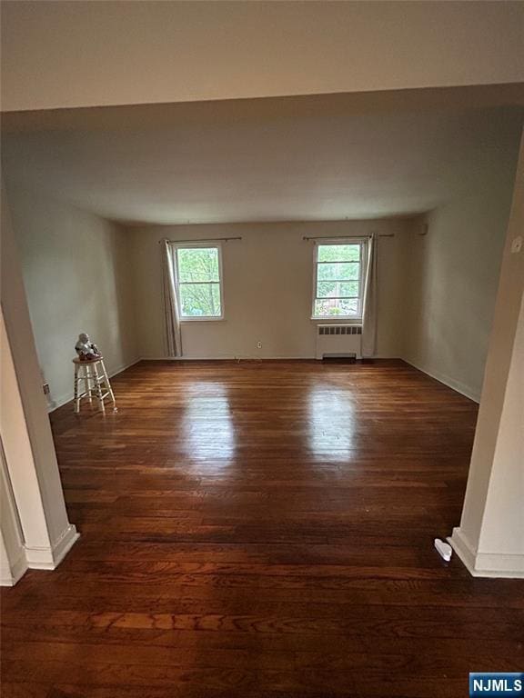 22 Cedar St Unit 2B, Ridgefield Park, NJ 07660 - unfurnished room featuring radiator, plenty of natural light, and wood finished floors