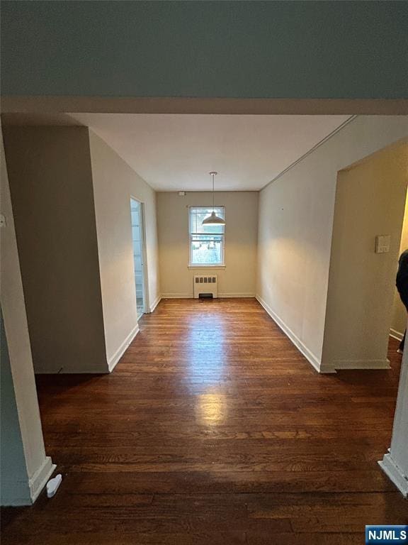 22 Cedar St Unit 2B, Ridgefield Park, NJ 07660 - unfurnished dining area with radiator heating unit and dark wood finished floors