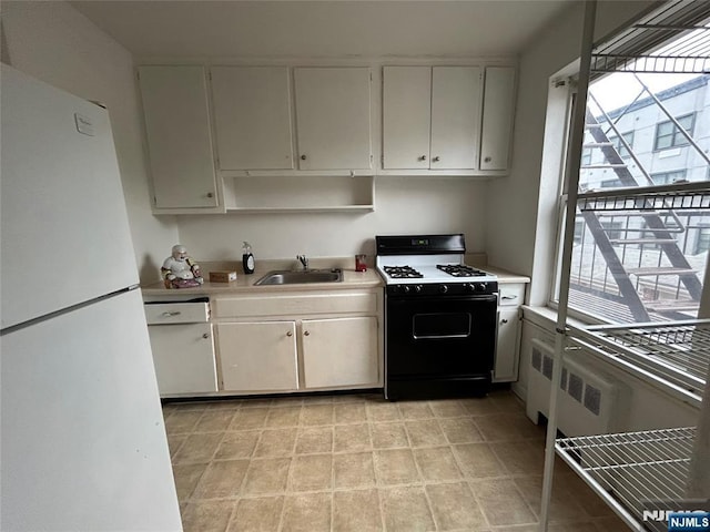 22 Cedar St Unit 2B, Ridgefield Park, NJ 07660 - kitchen with freestanding refrigerator, range with gas stovetop, light countertops, and plenty of natural light