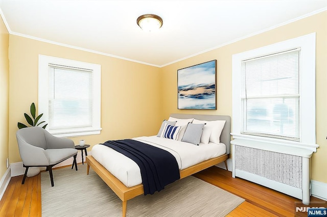 39 Lexington Ave, Bloomfield, NJ 07003 - bedroom with radiator, wood finished floors, and crown molding