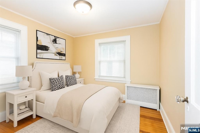 39 Lexington Ave, Bloomfield, NJ 07003 - bedroom featuring radiator, wood finished floors, and ornamental molding