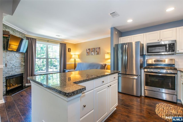 434 Cambridge Dr, Butler Borough, NJ 07405 - kitchen featuring stainless steel appliances, a kitchen island, white cabinetry, ornamental molding, and dark wood finished floors